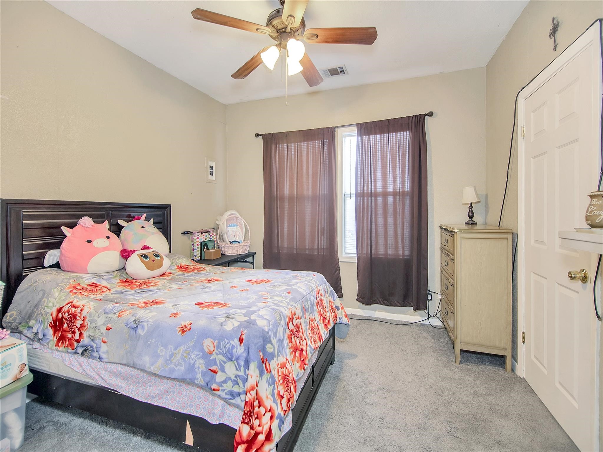 5207 McCormick Street Houston, TX 77023 - Photo 22 of 33 a bedroom with a bed and a chandelier