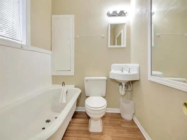 a bathroom with a toilet sink and mirror