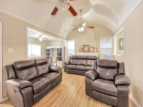 a living room with furniture ceiling fan and a rug