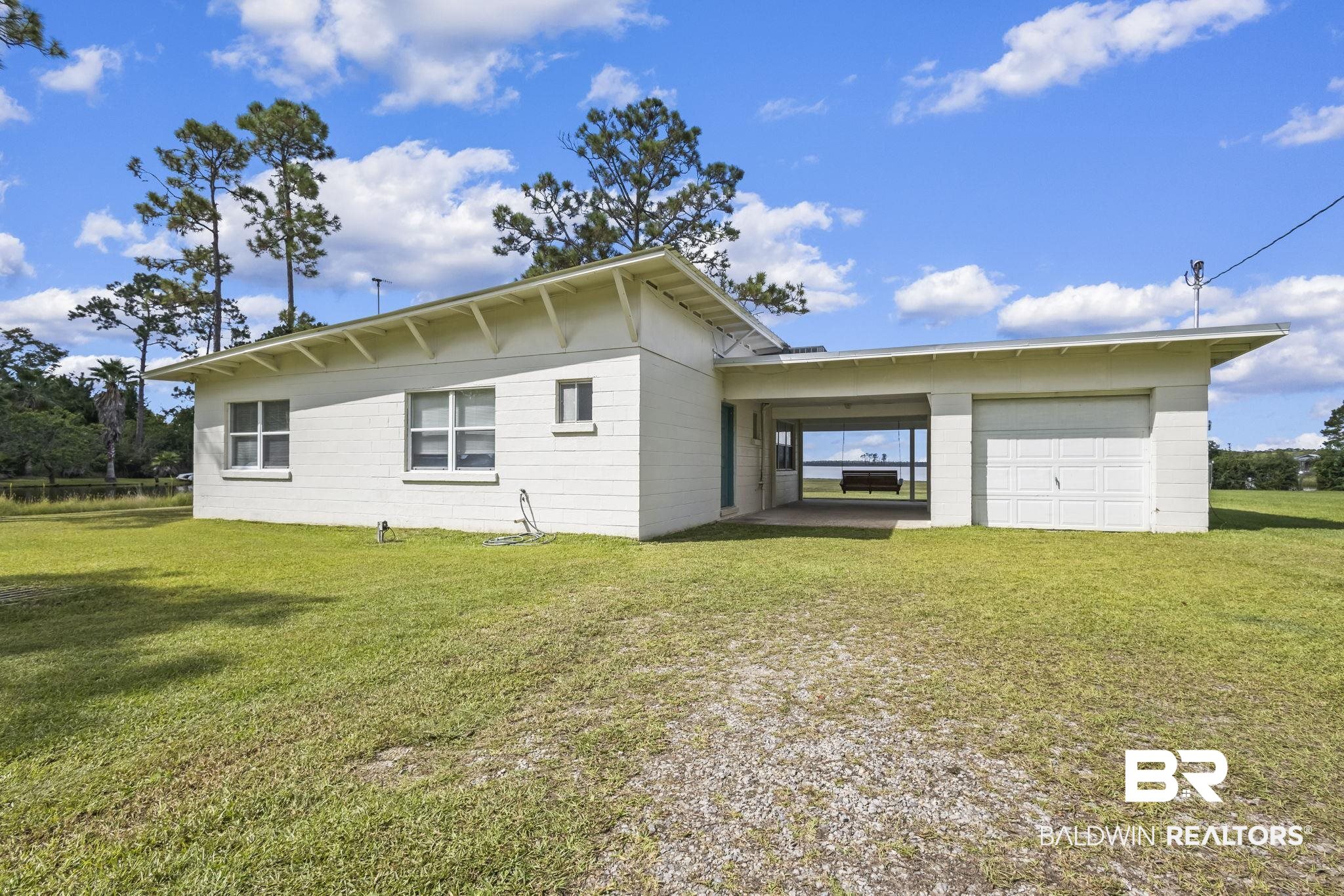 7849 Bayshore Drive Elberta, AL 36530 - Photo 4 of 47 Back of property featuring a lawn