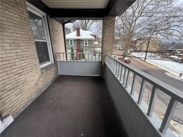 a view of balcony with wooden floor