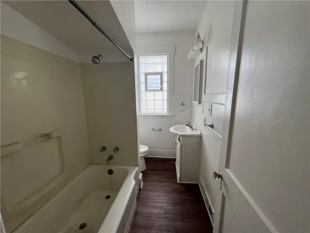 a bathroom with a tub sink and toilet