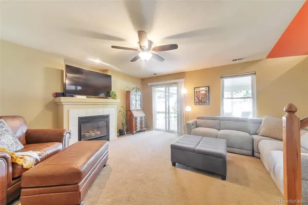 a living room with furniture a fireplace and a flat screen tv
