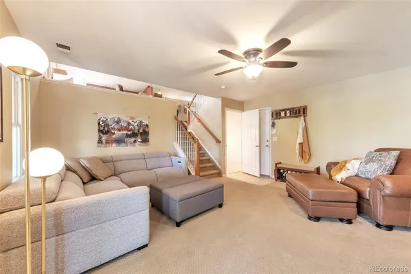 a living room with furniture and a chandelier
