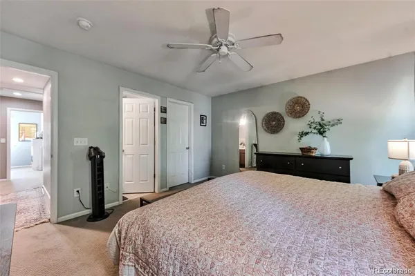 a bedroom with a large bed and a chandelier