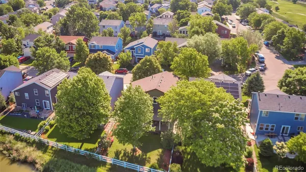 an aerial view of residential houses with outdoor space and street view
