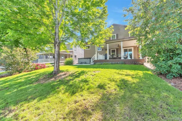 a front view of a house with yard and green space