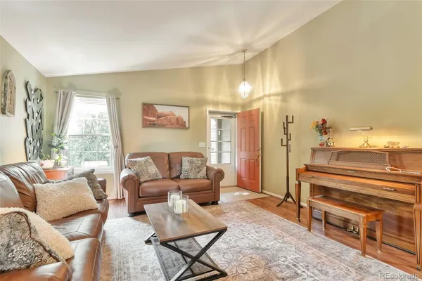a living room with furniture and a floor to ceiling window
