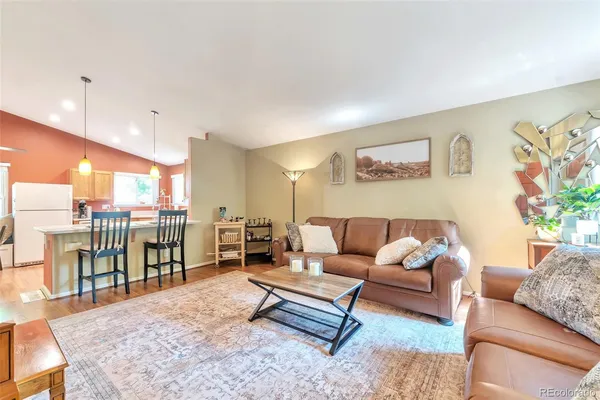 a living room with furniture a rug and a table