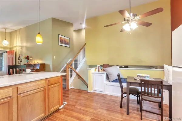 a view of a dining room with furniture and a chandelier fan