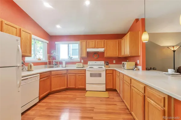 a kitchen with a sink window and cabinets