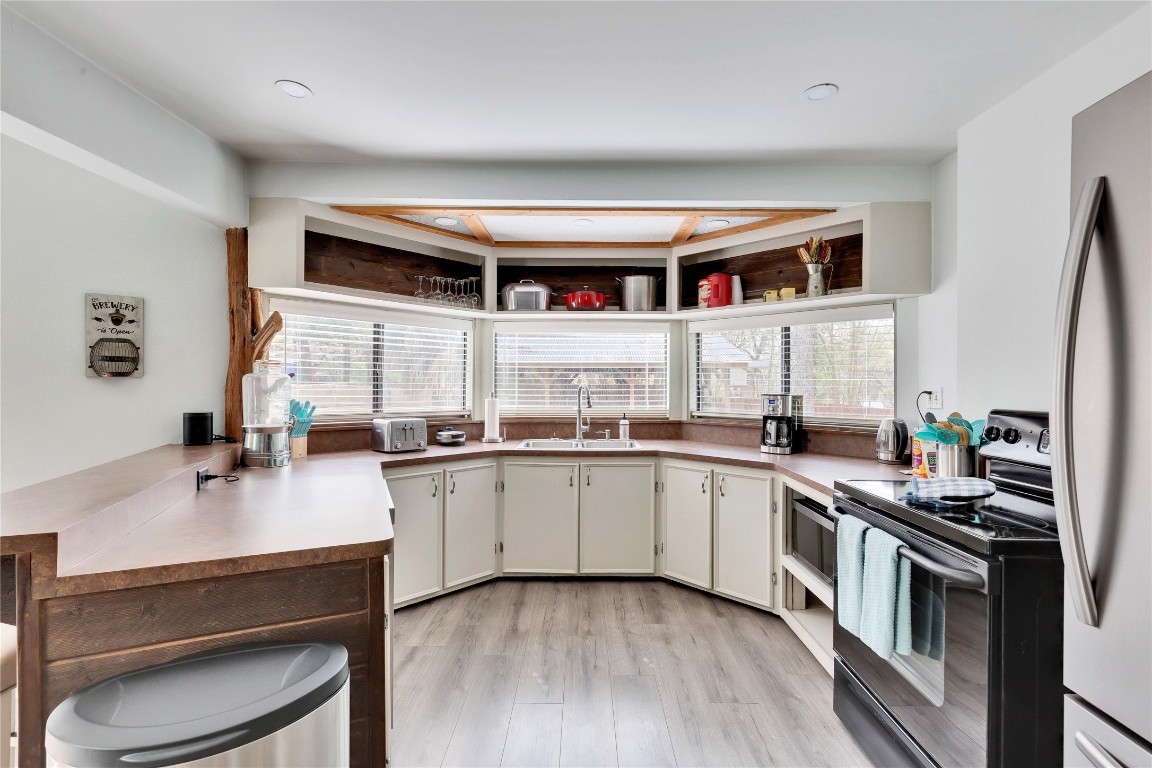 16108 Aqua Azul Path Austin, TX 78734 - Photo 14 of 40 a kitchen with stainless steel appliances a sink and a stove
