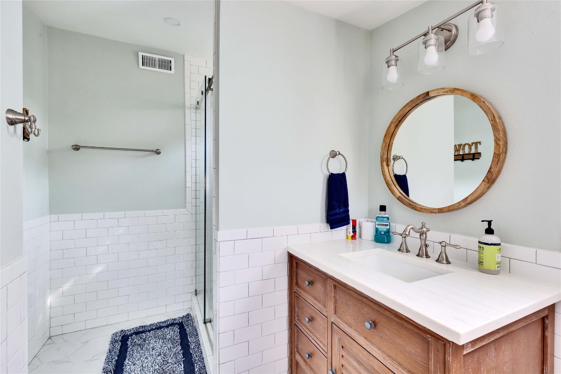 16108 Aqua Azul Path Austin, TX 78734 - Photo 23 of 40 a bathroom with a sink vanity mirror and a mirror