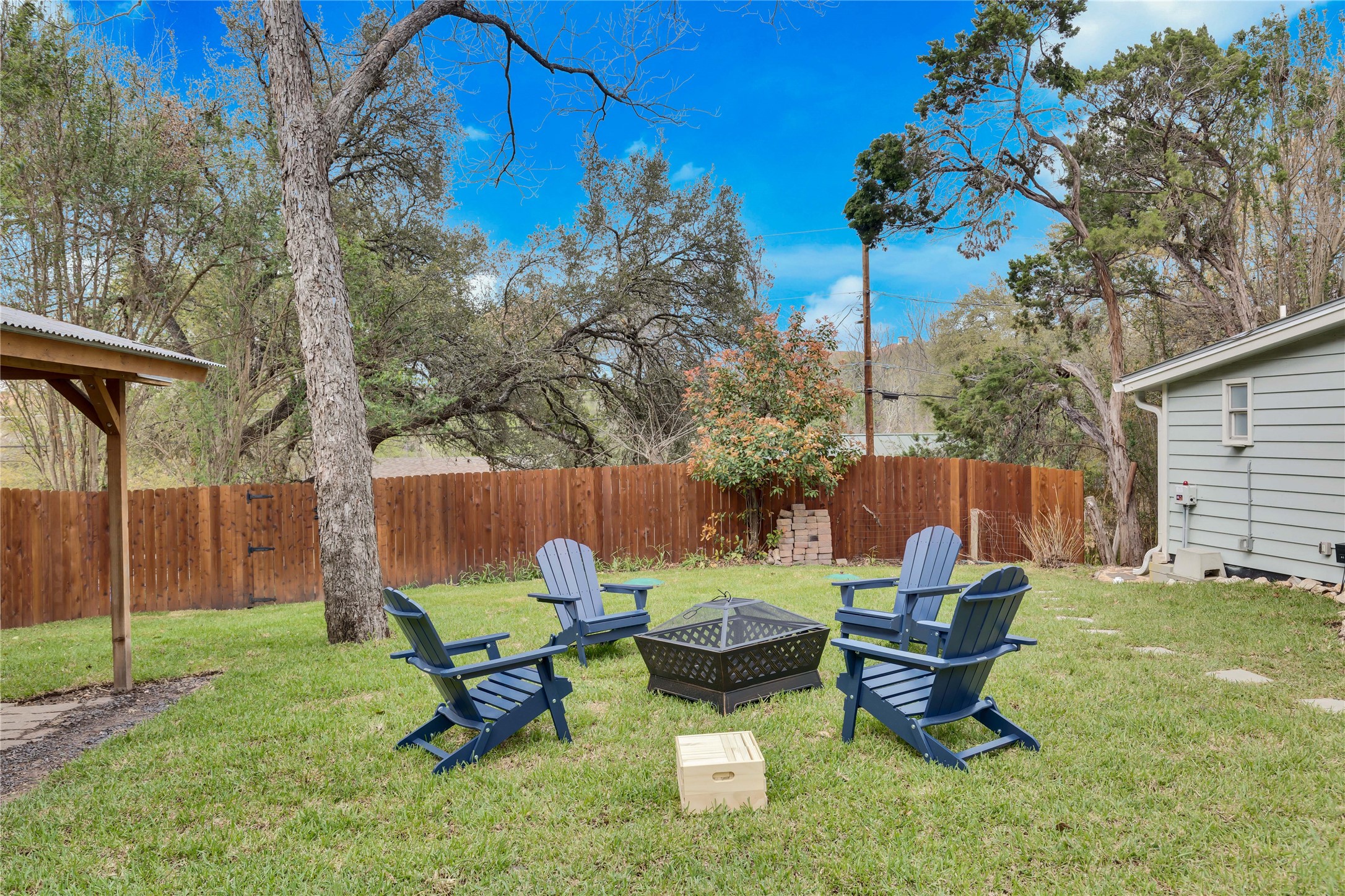 16108 Aqua Azul Path Austin, TX 78734 - Photo 33 of 40 a backyard of a house with table and chairs