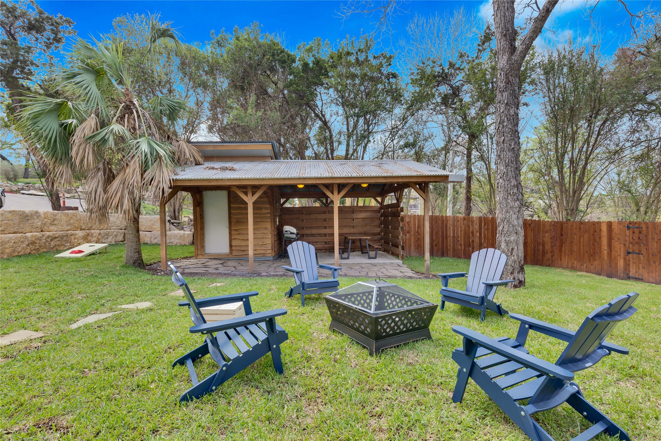 16108 Aqua Azul Path Austin, TX 78734 - Photo 34 of 40 a view of a backyard with chairs potted plants and a large tree