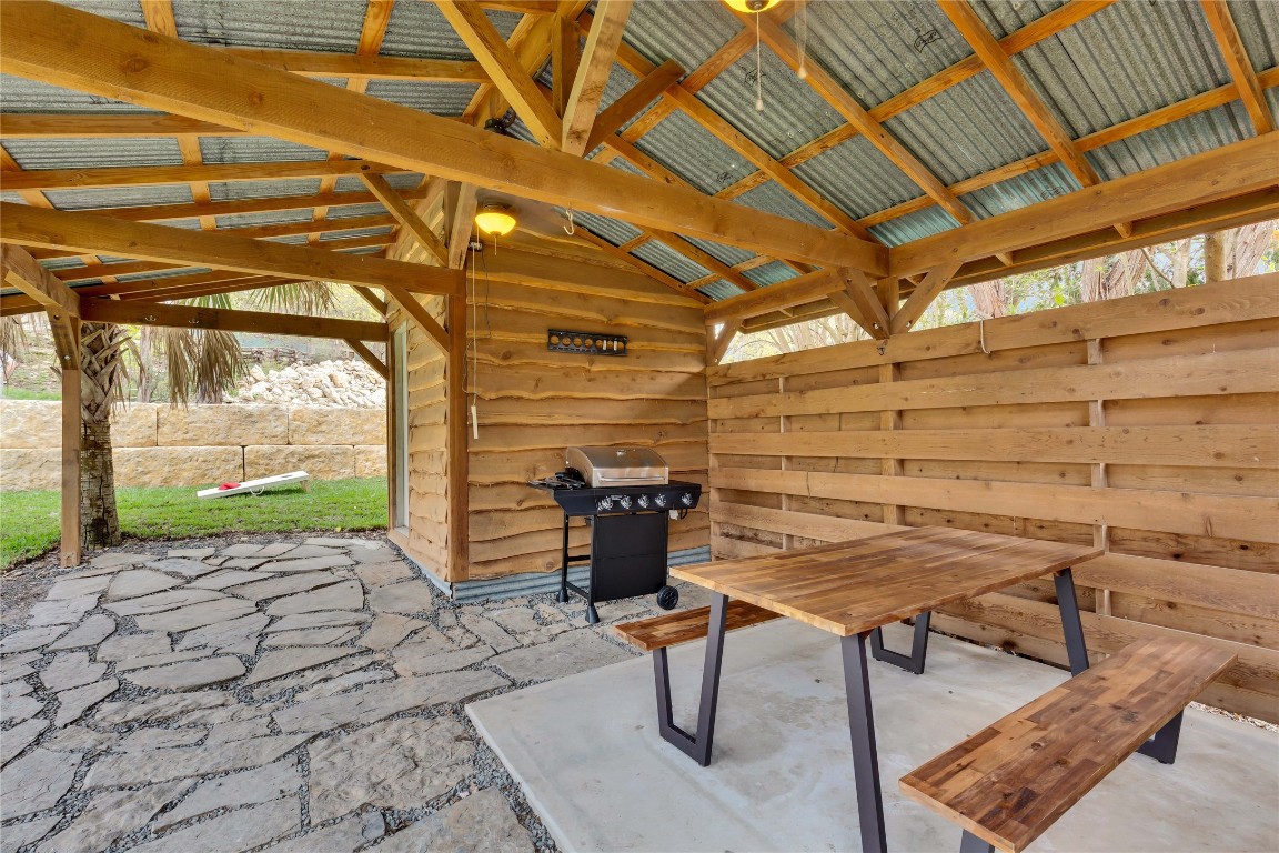 16108 Aqua Azul Path Austin, TX 78734 - Photo 35 of 40 a view of a patio with table and chairs with wooden floor and fence