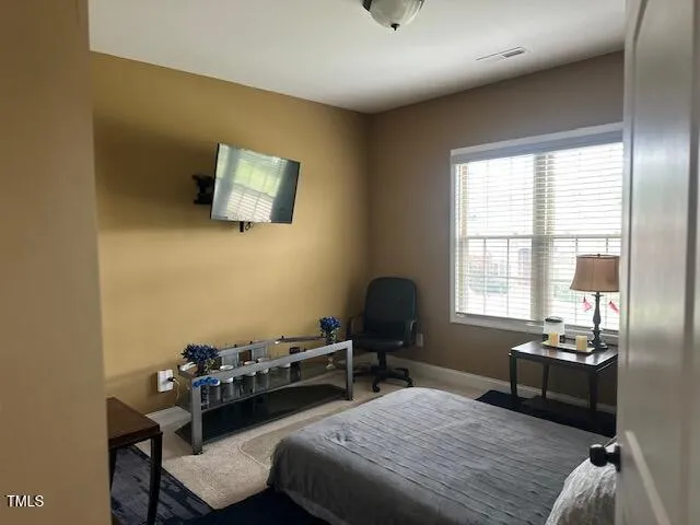 a bedroom with a bed and a lounge chair