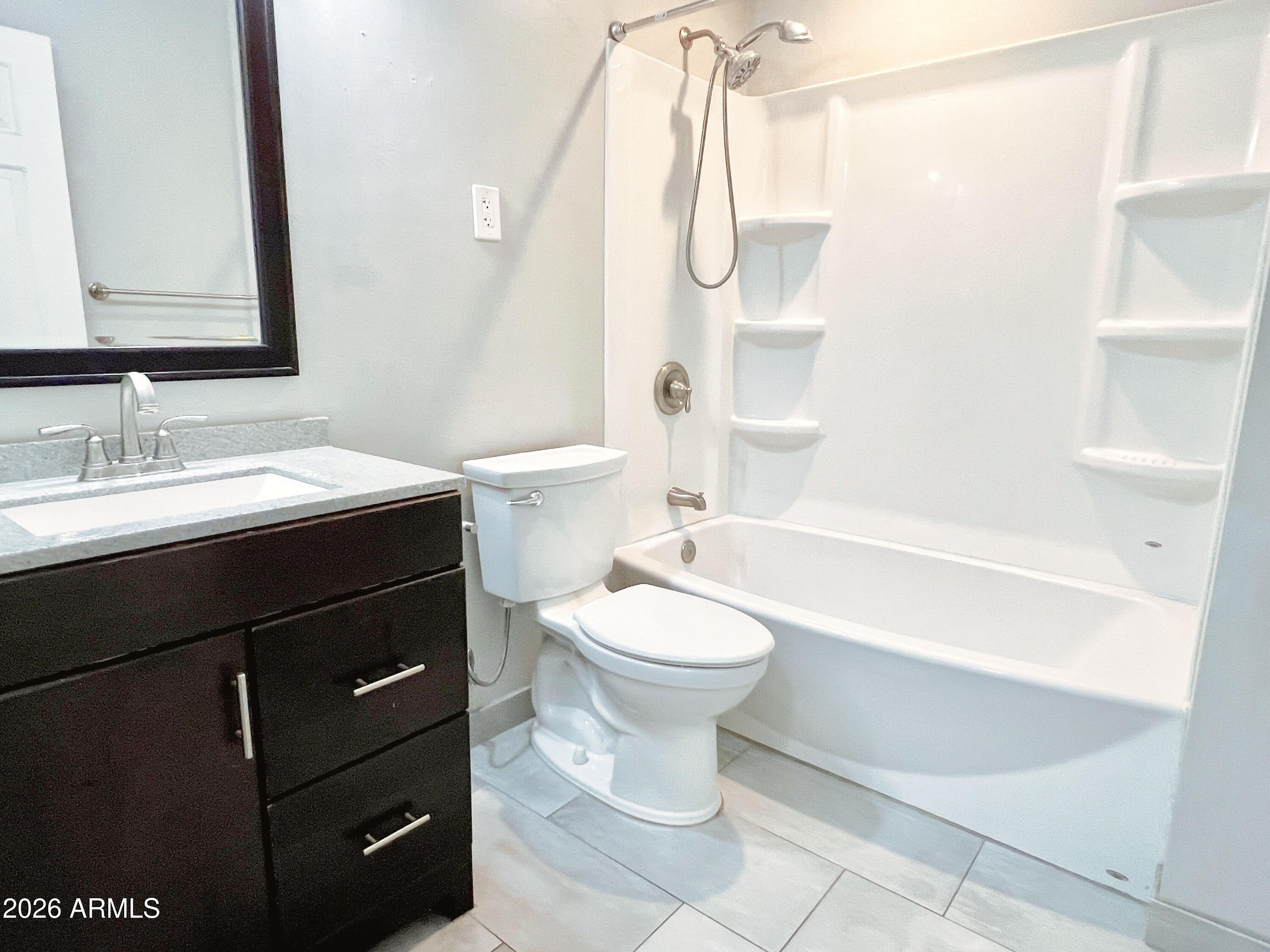 1220 West Romo Jones Street Tempe, AZ 85281 - Photo 23 of 26 a bathroom with a sink a toilet and a bathtub