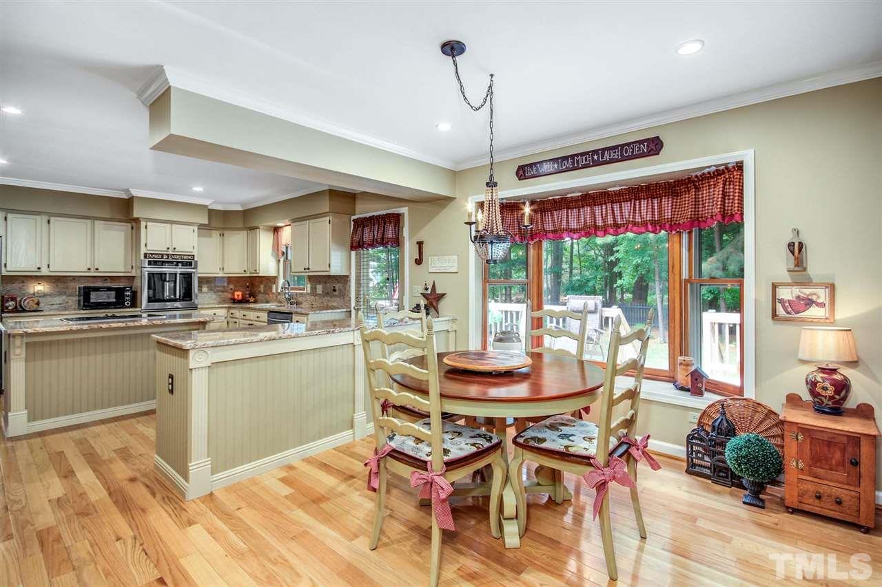 3148 Mt Vernon Church Road Raleigh, NC 27613 - Photo 12 of 29 a kitchen with a table and chairs in it