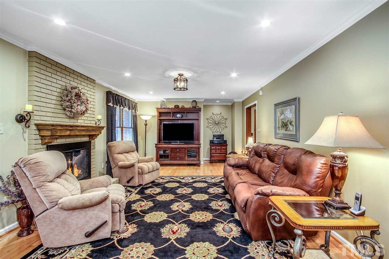3148 Mt Vernon Church Road Raleigh, NC 27613 - Photo 13 of 29 a living room with furniture a flat screen tv and a fireplace