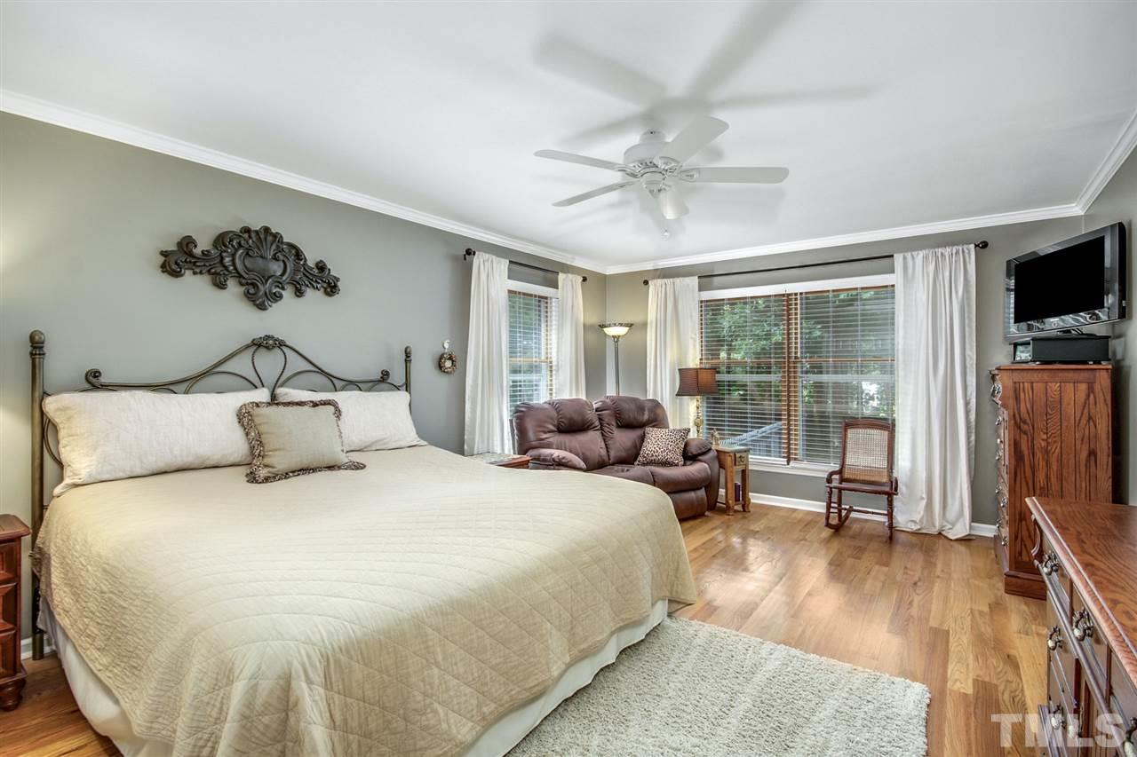3148 Mt Vernon Church Road Raleigh, NC 27613 - Photo 15 of 29 a large white bed in a room next to a window and a flat screen tv