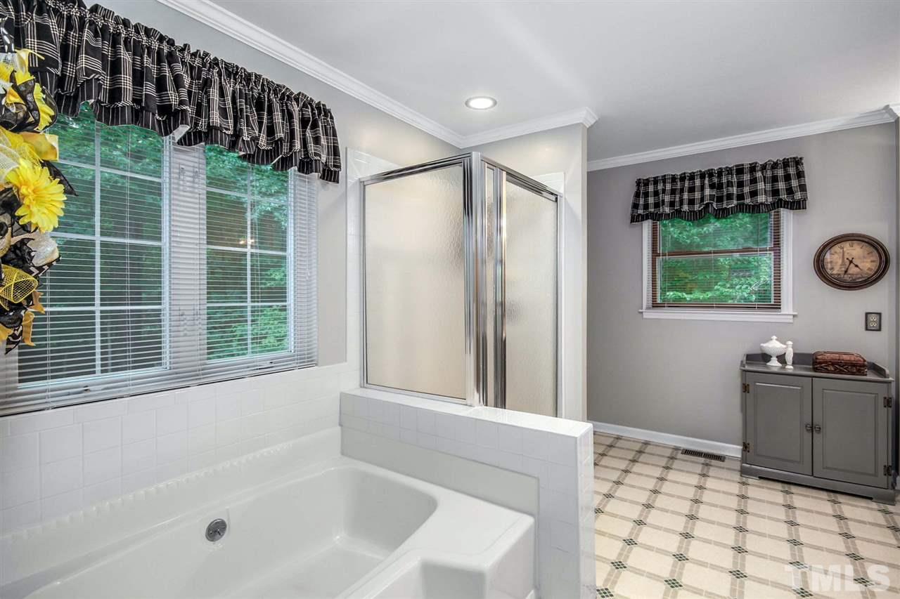 3148 Mt Vernon Church Road Raleigh, NC 27613 - Photo 17 of 29 a bathroom with a bathtub and a sink