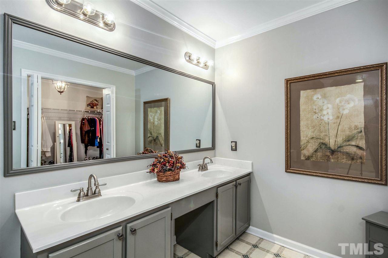 3148 Mt Vernon Church Road Raleigh, NC 27613 - Photo 18 of 29 a bathroom with a sink and a mirror
