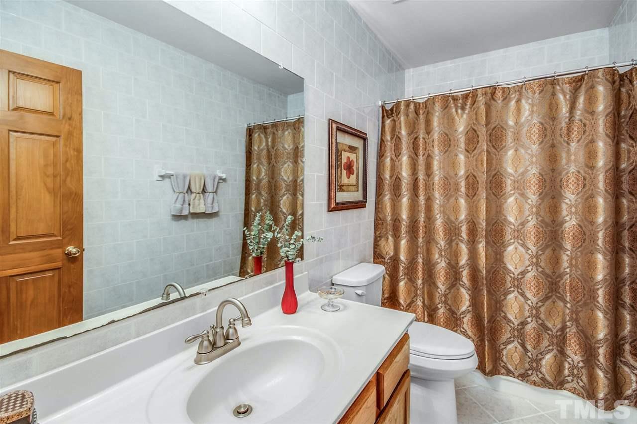 3148 Mt Vernon Church Road Raleigh, NC 27613 - Photo 20 of 29 a bathroom with a sink toilet and shower