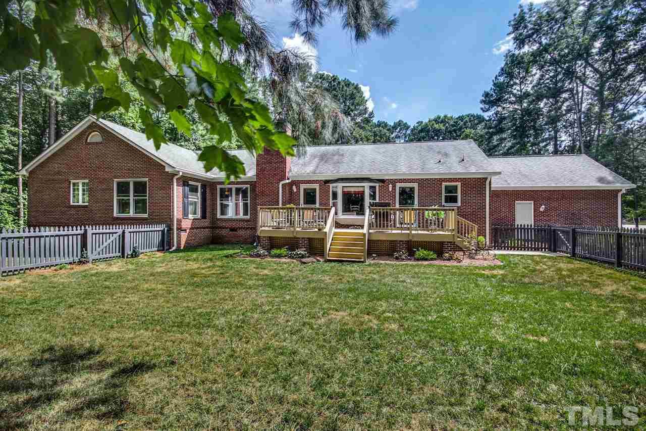 3148 Mt Vernon Church Road Raleigh, NC 27613 - Photo 28 of 29 a front view of a house with a garden and trees