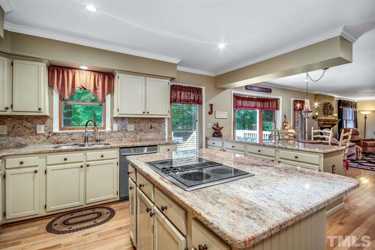 3148 Mt Vernon Church Road Raleigh, NC 27613 - Photo 10 of 29 a kitchen with stainless steel appliances granite countertop a sink stove and cabinets