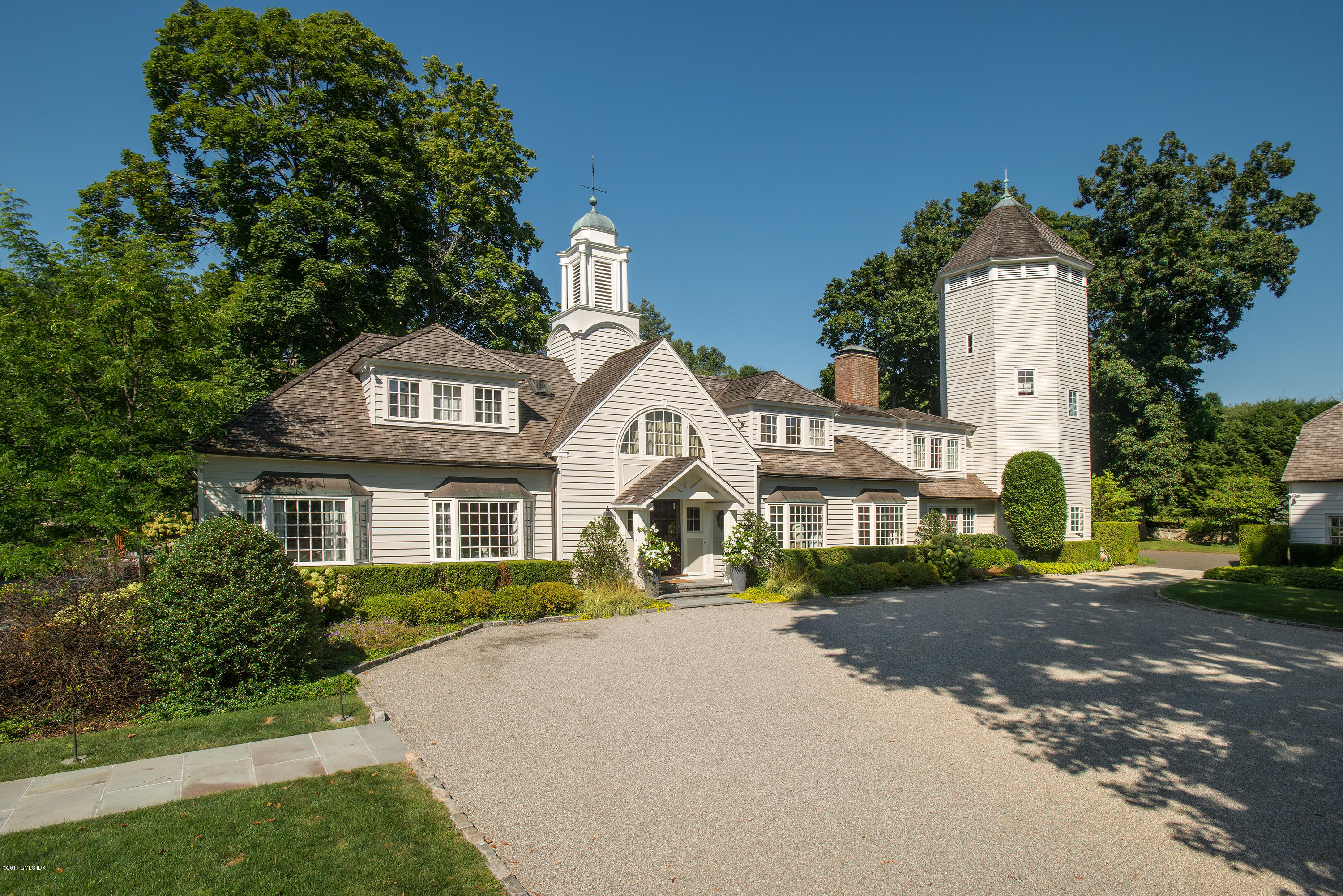 8 Mountain Wood Drive Greenwich, CT 06830 - Photo 1 of 22 a front view of a house with a garden