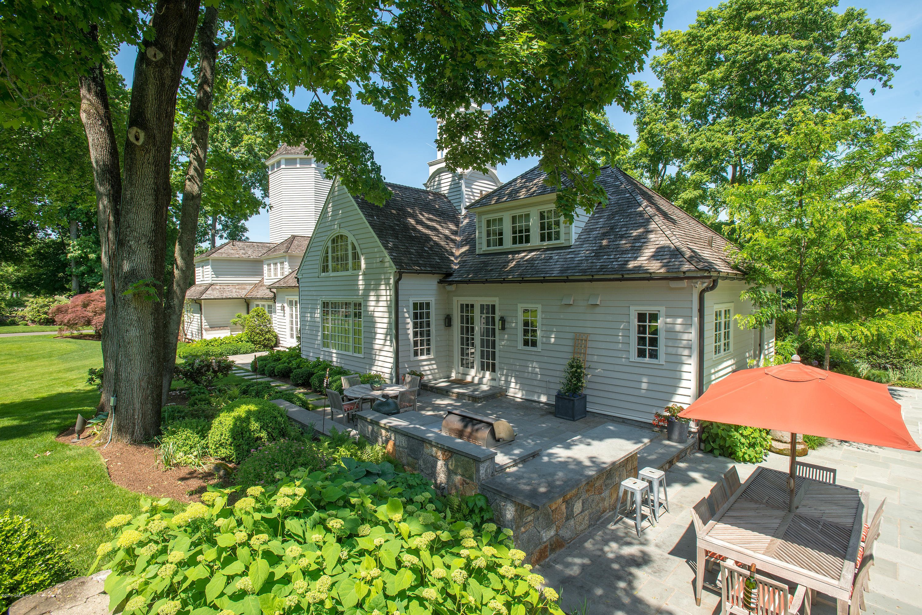 8 Mountain Wood Drive Greenwich, CT 06830 - Photo 12 of 22 a front view of a house with garden