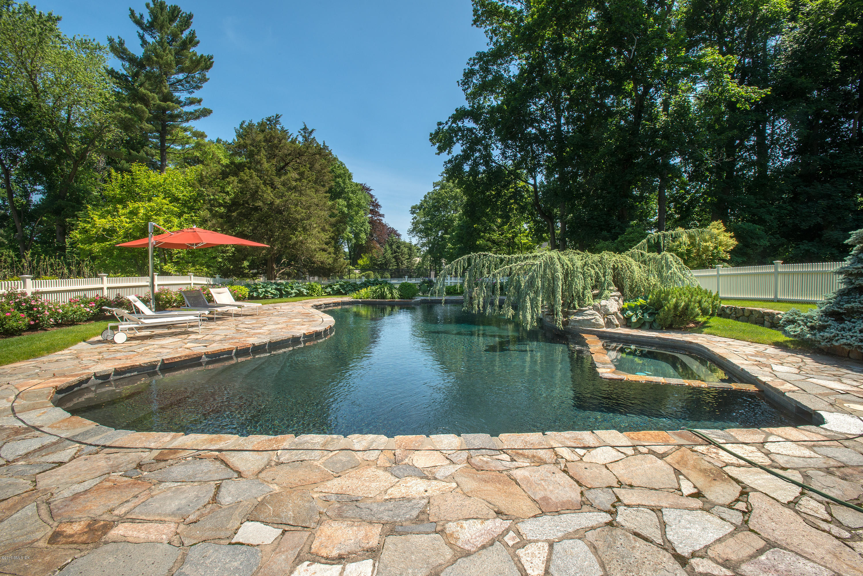 8 Mountain Wood Drive Greenwich, CT 06830 - Photo 17 of 22 a view of swimming pool with a garden and trees