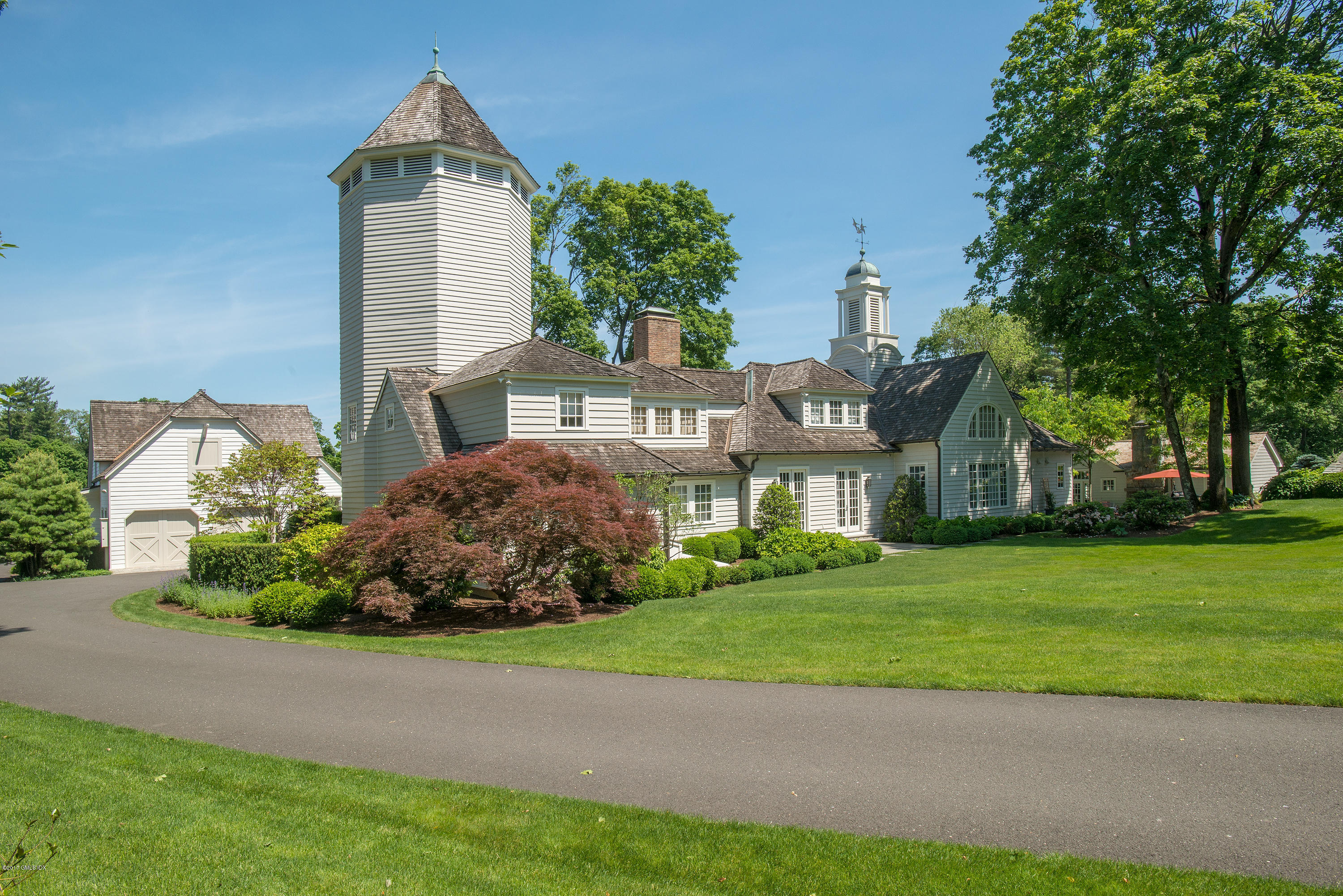 8 Mountain Wood Drive Greenwich, CT 06830 - Photo 22 of 22 a front view of a house with a garden and trees