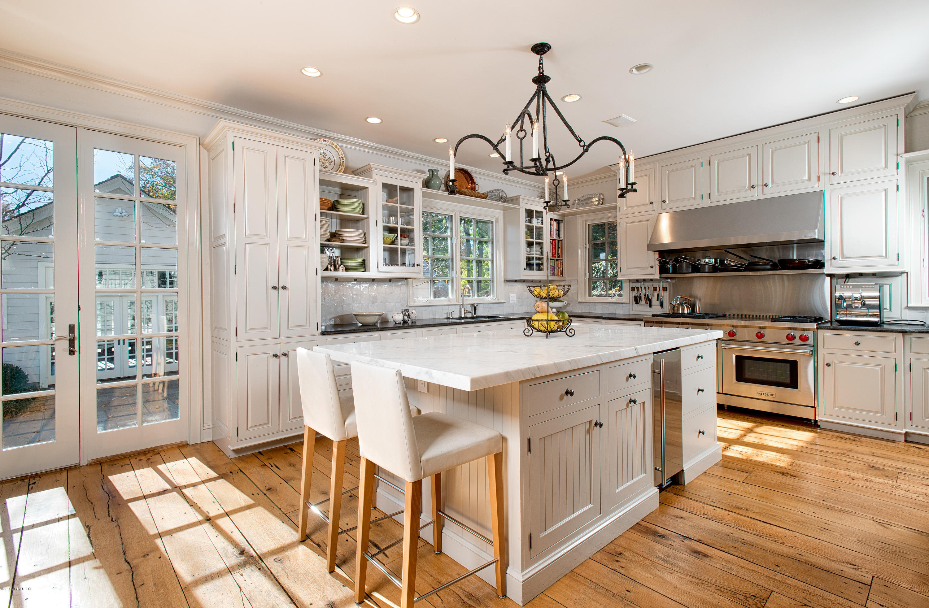8 Mountain Wood Drive Greenwich, CT 06830 - Photo 6 of 22 a kitchen with stainless steel appliances a stove a sink island and a refrigerator