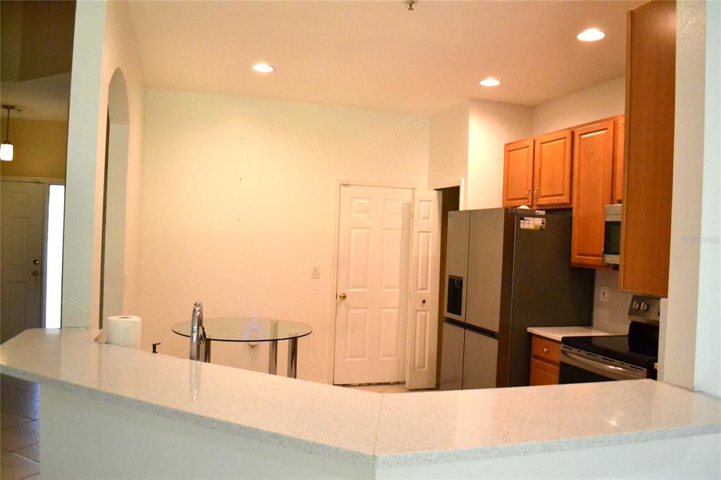 11235 Kapok Grand Circle Madeira Beach, FL 33708 - Photo 3 of 34 a kitchen with refrigerator and window