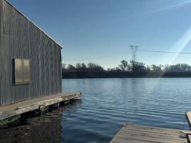 a view of a balcony with wooden floor and lake view