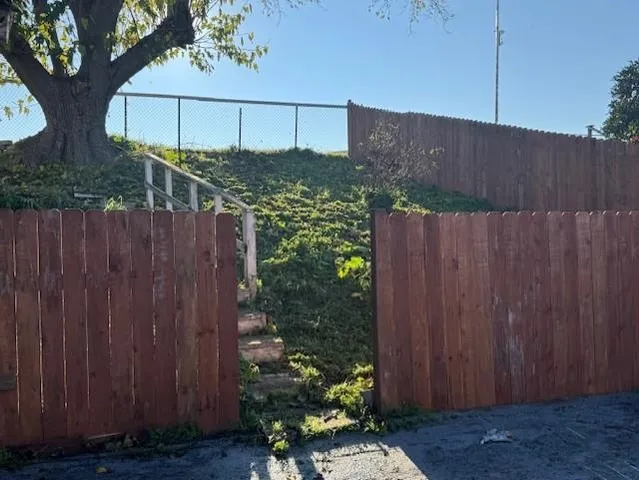 a view of a house with wooden fence