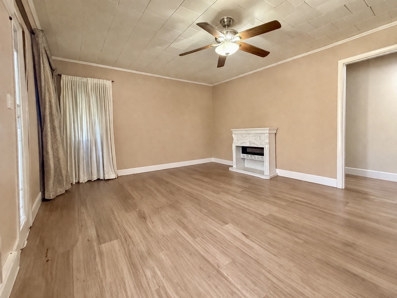 2705 Johnson Branch Road Leoma, TN 38468 - Photo 5 of 16 an empty room with wooden floor ceiling fan and windows