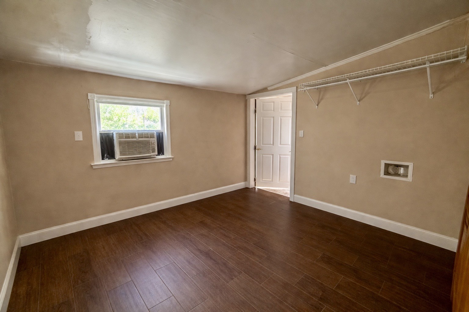 2705 Johnson Branch Road Leoma, TN 38468 - Photo 8 of 16 a view of an empty room with wooden floor and a window