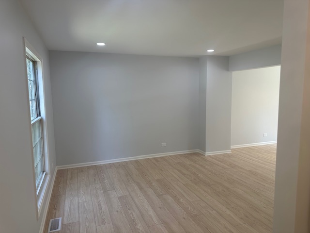 1311 Blue Ridge Parkway Algonquin, IL 60102 - Photo 3 of 21 a view of an empty room with wooden floor and a window