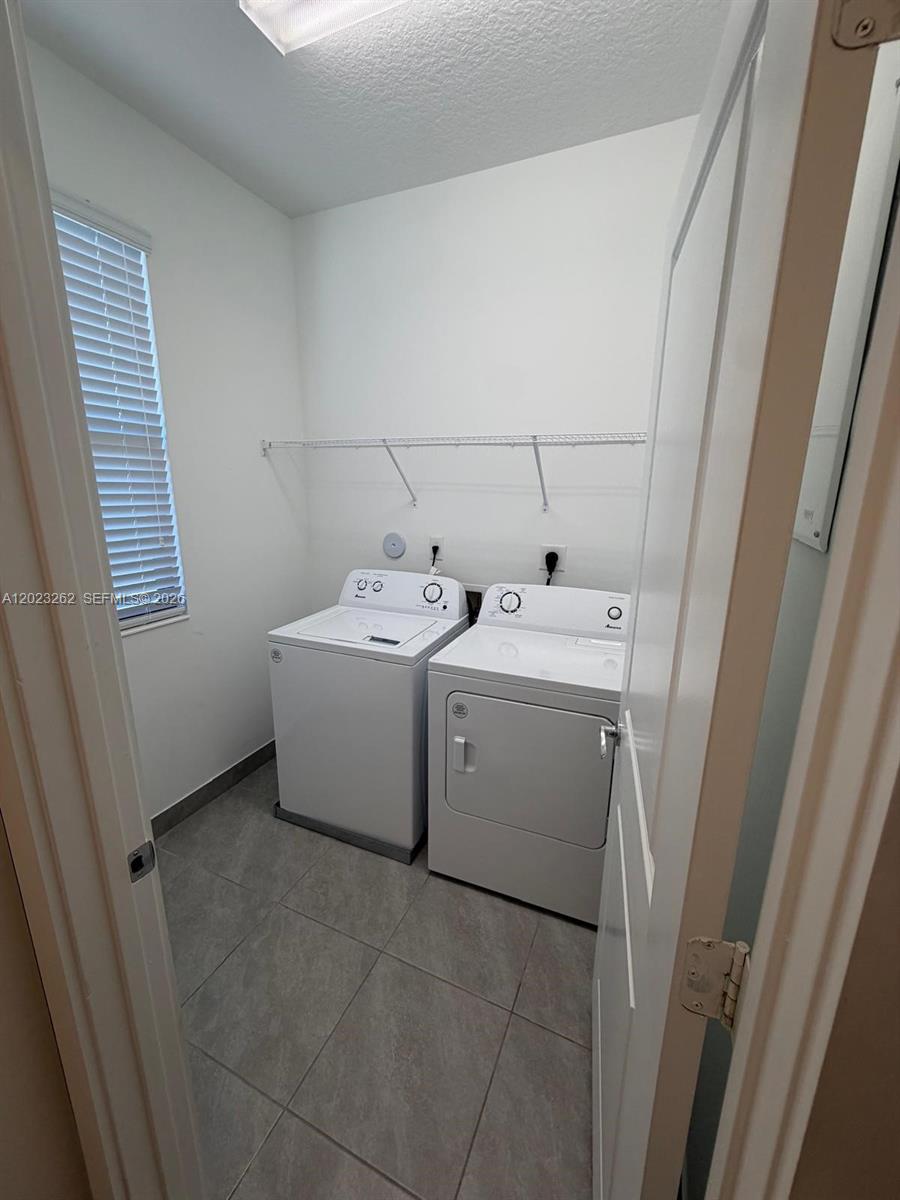 5669 Cerva Lane, Unit 5669 Immokalee, FL 34142 - Photo 11 of 32 a utility room with dryer and washer