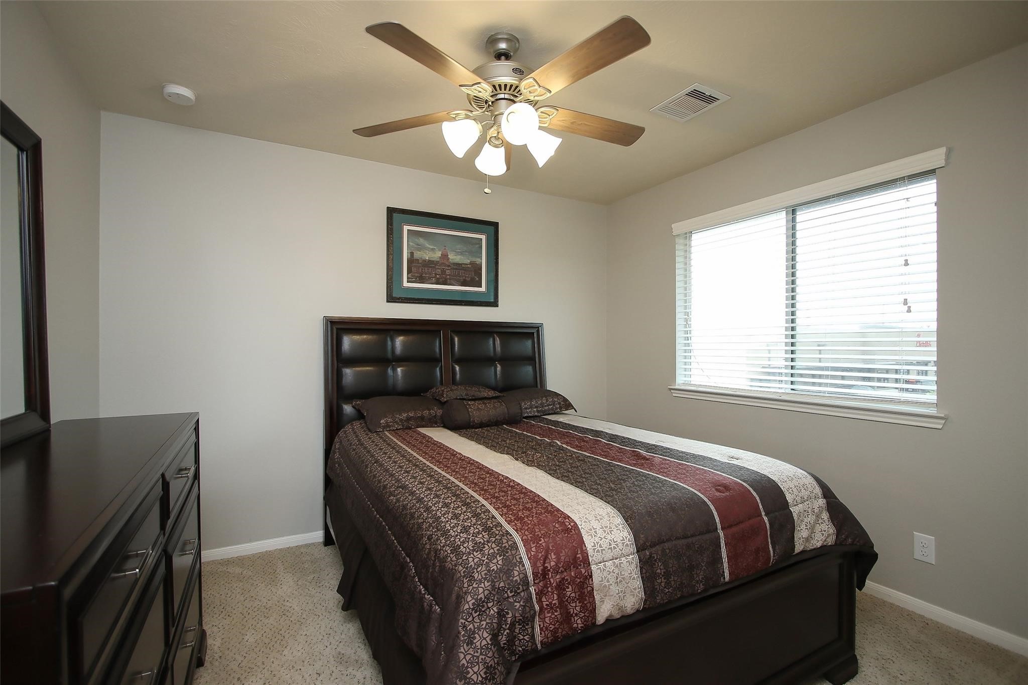 8517 Sunset Loch Drive Spring, TX 77379 - Photo 19 of 22 a bedroom with a bed and a chandelier