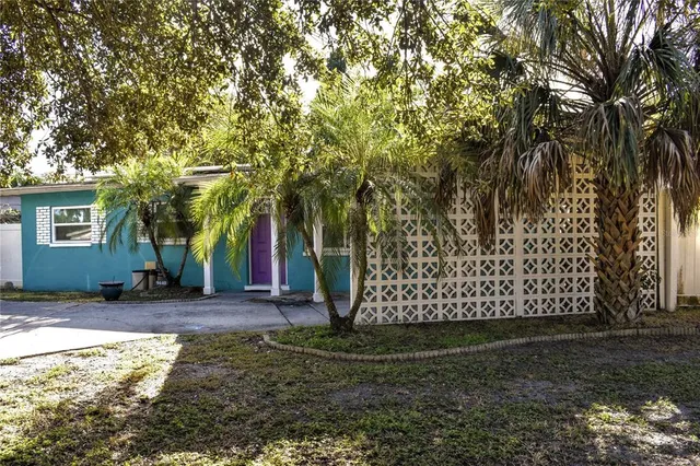 a view of a yard with large trees