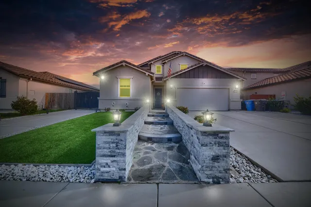 a front view of a house with a yard and garage