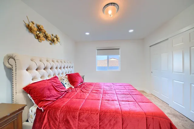 a bedroom with a bed and a window