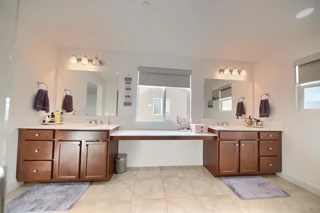 a large bathroom with a double vanity sink and a mirror