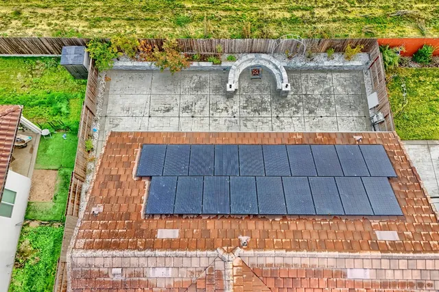 a backyard of a house with a fountain and a bench