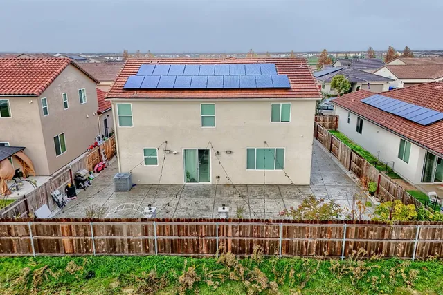 a view of a house with wooden fence