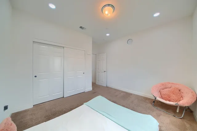 a bedroom with a bed and toilet